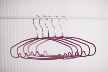 Empty hangers on rack in room close up. Selective focus.