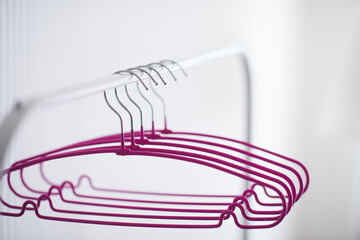 Empty hangers on rack in room close up. Selective focus.