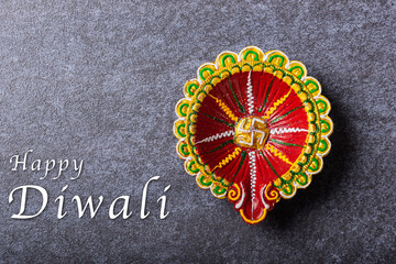 Top view overhead clay lit Diya or oil lamp, studio shot on concrete background, Decoration of Hinduism rangoli, Happy Deepavali or Diwali festival concept