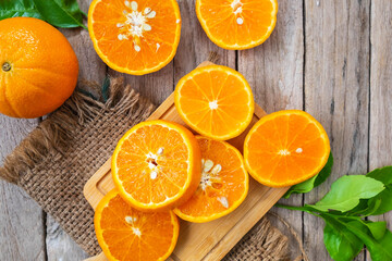 Obraz na płótnie Canvas Fresh oranges fruit slice on a wooden
