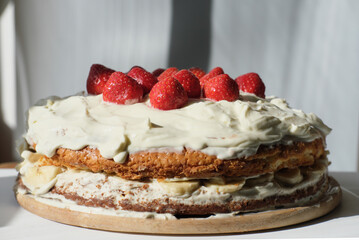 homemade pie with strawberry topping and cream. home bakery and hand made pastry. holiday selebratinng with family and kids. treats for kids.