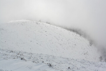 snow covered mountains and scenic fog