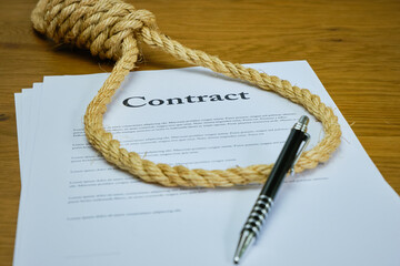 Contract with pen and rope tied in hangmans noose. Strangulation contract, unfair agreement. Lorum...
