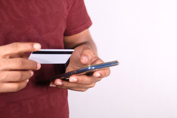 Man hand holding credit card and using smart phone shopping online 