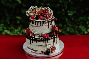 cake with roses.huge  cream and chocolate cake with natural figs and flowers