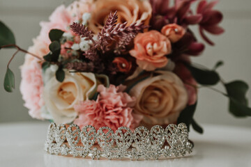 diamond bridal tiara with her bouquet of flowers in the background