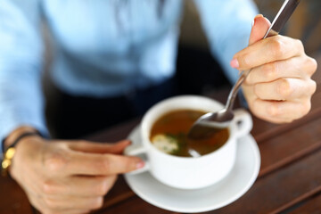 Woman eating soup