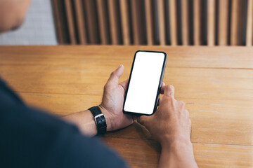 cell phone mockup blank white screen.man hand holding texting using mobile on desk at coffee shop.background empty space for advertise.work people contact marketing business,technology