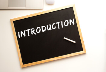 The text is written in chalk on a slate board. business concept