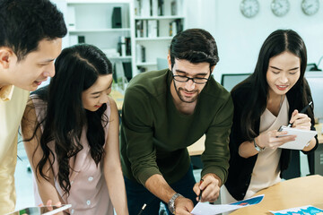 group of colleagues young business people in smart casual working and brainstorm planning new project on desk in meeting room at modern office, digital marketing, business meeting startup concept