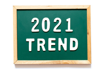 Fototapeta premium Green blackboard and wood frame with word 2021 trend on white background