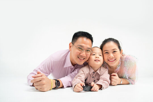 south-east - chinese asian family lie down on the floor with smile