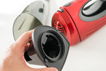 Close-up view of a red car vacuum cleaner taken apart