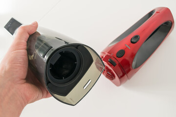 Close-up view of a red car vacuum cleaner taken apart