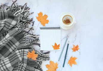 coffee cup, notepad, maple leaves and plaid. cozy autumn composition. fall, thanksgiving day concept. Flat lay, top view. copy space