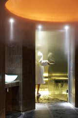 Woman wearing bathrobe entering hamam -  Aix-en-Provence, France © Denis Dalmasso - Tel: +33 (0) 615 244 984 - E-mail : contact@denisdalmasso.com