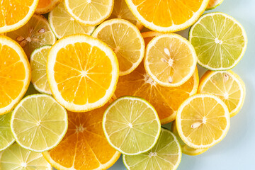Fototapeta premium sliced colorful juicy assorted citrus fruits shot from above flat lay