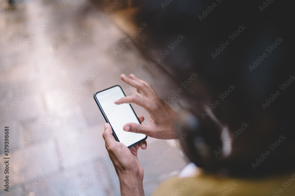 Poster cropped image of man holding smartphone with blank monitor using navigation application for searchin