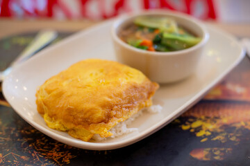 golden fried omelet topped on steam rice