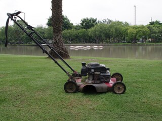 old lawn mower on the lawn in a garden