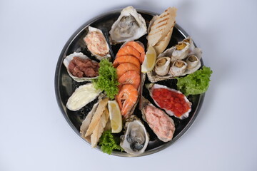 a plate of assorted seafood on a white background