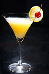 yellow cocktail on dark background