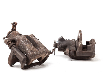 Close up old, worn out and rusty car caliper of brake system on white isolated background. Auto...