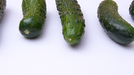 Young green cucumbers close up on white background
