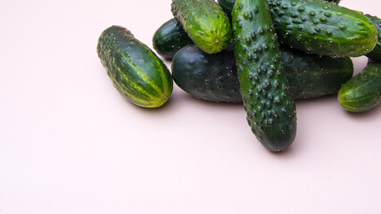 Young green cucumbers close up on white background