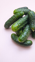 Young green cucumbers close up on white background