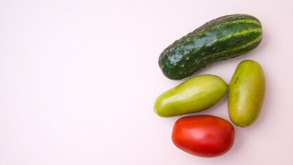 Cucumber, green and red tomatoes, close-up white background