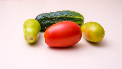 Cucumber, green and red tomatoes, close-up white background