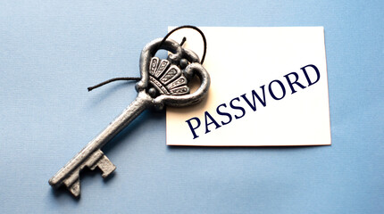 PASSWORD - word on white paper on a wooden background with a beautiful key