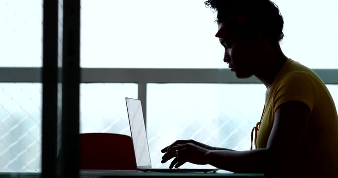 Latina hispanic woman typing on laptop computer