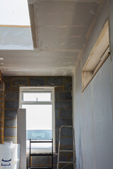 Property extension plasterboarding, drywall, dab and dot method. Unfinished walls and ceilings, selective focus