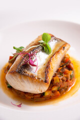 fine fish fillet steak on vegetable salsa