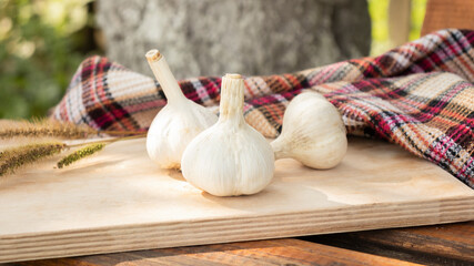 Garlic. sliced garlic, garlic clove, garlic bulb in wooden bowl place on chopping block on vintage wooden background. Place for text, copy space Concept of healthy food. Top view