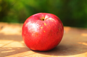 Ripe red apple on table close up