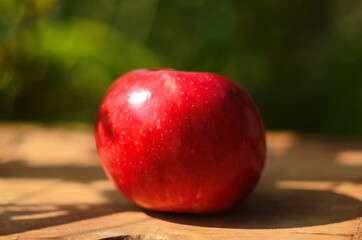 Ripe red apple on table close up
