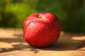 Ripe red apple on table close up