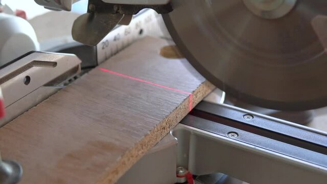 cutting a chipboard plate with circular saw
