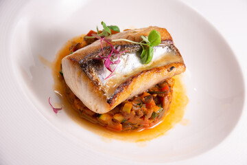 fine fish fillet steak on vegetable salsa