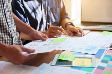 Designers work together to design website and office applications.