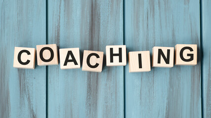 coaching word on a wooden blocks, business concept.