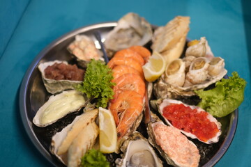 a plate of assorted seafood on a blue background in top view