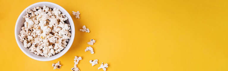 Bowl of popcorn on yellow background