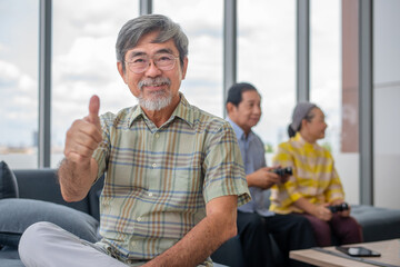asian grandpa thumb up with other retired on background