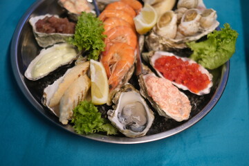 a plate of assorted seafood on a blue background in top view
