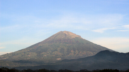 The peak of the mountain is visible in the morning when the weather at the top is sunny. A...