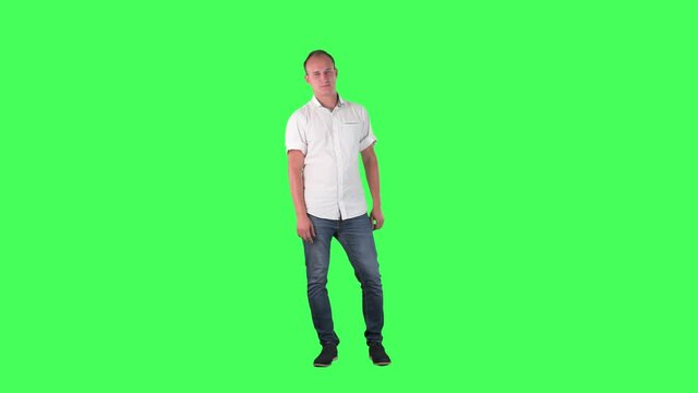Young standing business man winking and flirting at camera. Full body on green screen. 